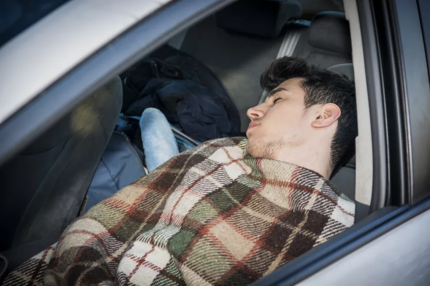 young-handosme-man-sleeping-in-his-car