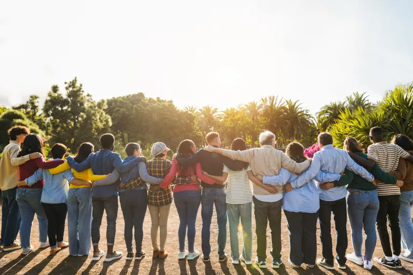 group-of-multigenerational-people-hugging-each-others-support-multiracial-and-diversity-concept-main-focus-on-senior-man-with-white-hairs