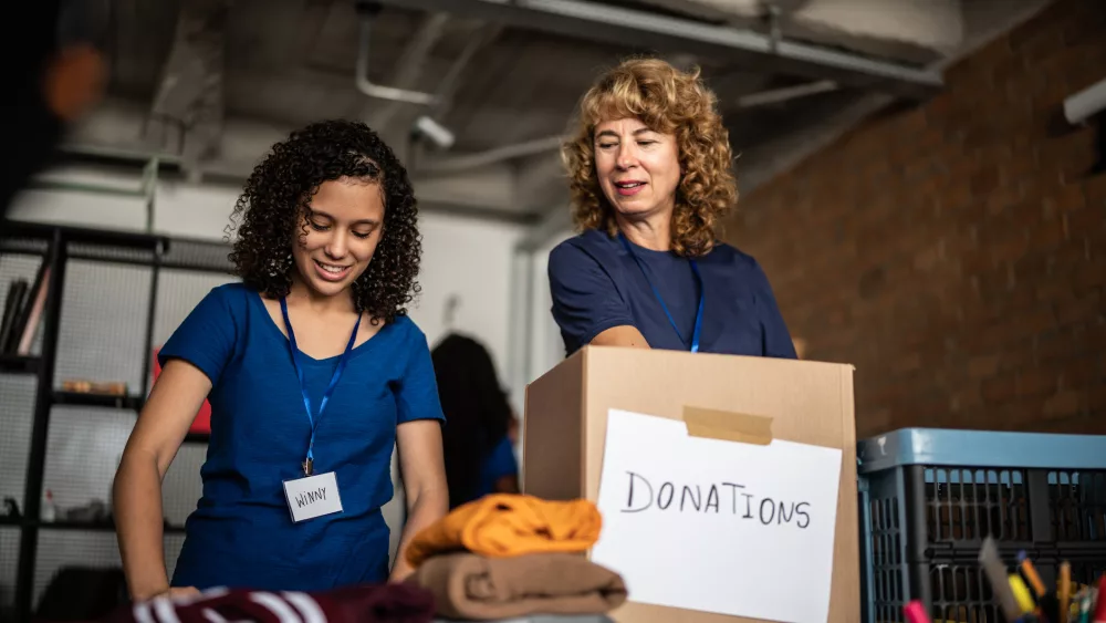 volunteers-arranging-clothes-donations-in-a-community-charity-donation-center