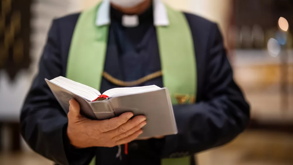 priest-reading-bible-during-congregation-in-church