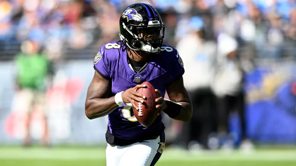 BALTIMORE, MARYLAND - OCTOBER 22: Lamar Jackson #8 of the Baltimore Ravens rolls out of the pocket against the Detroit Lions at M&T Bank Stadium on October 22, 2023 in Baltimore, Maryland. (Photo by G Fiume/Getty Images)