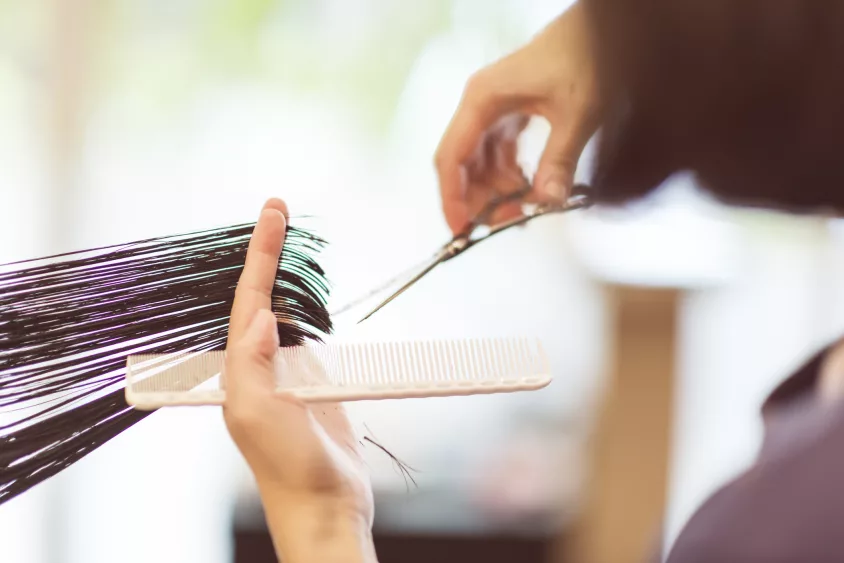 hairdresser-using-scissors-to-cut-hair