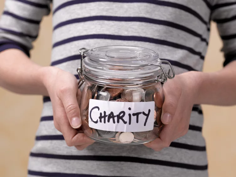 10-year-old-holding-charity-donations-in-a-jar