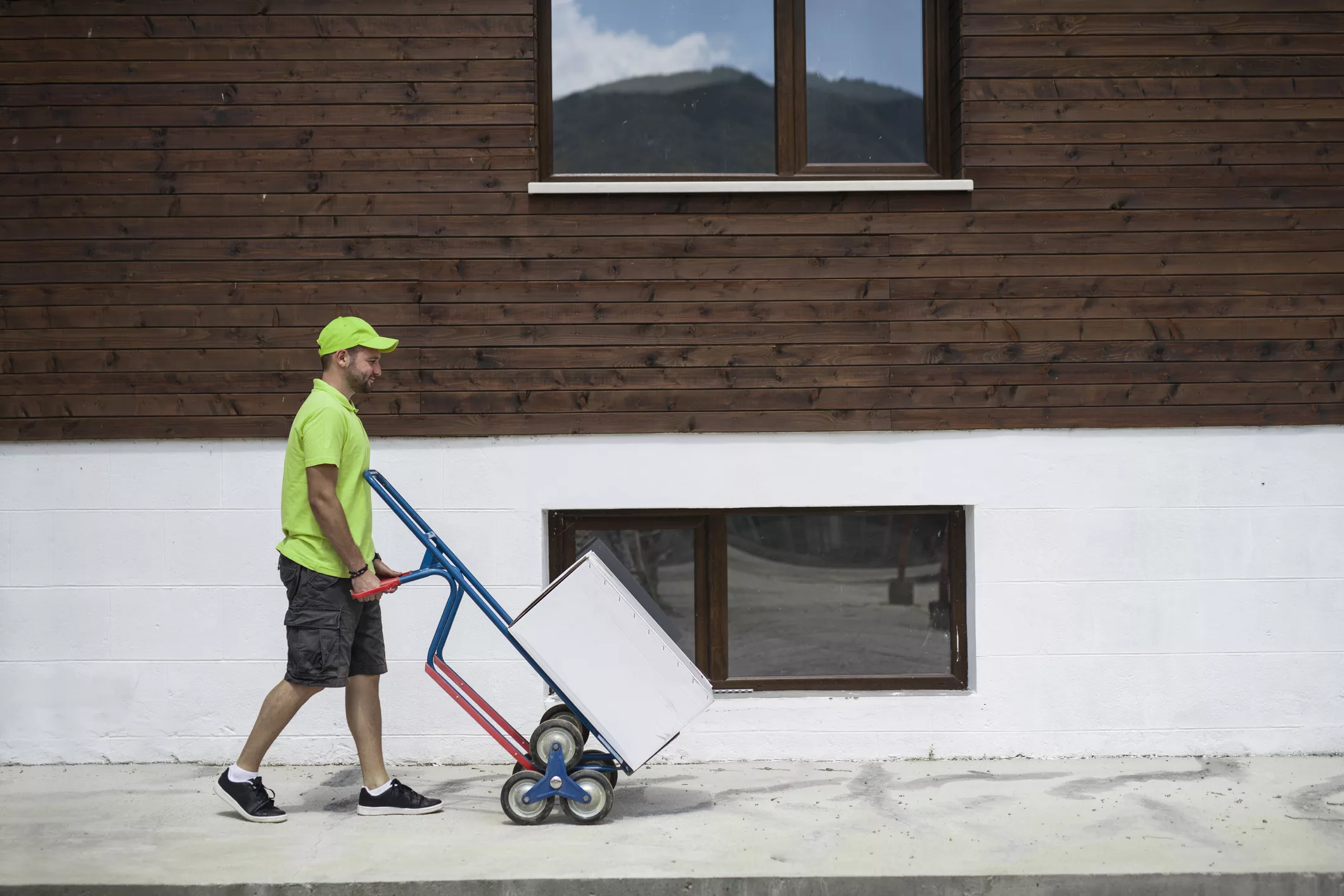 delivery-man-pushing-dolly-to-home-delivery