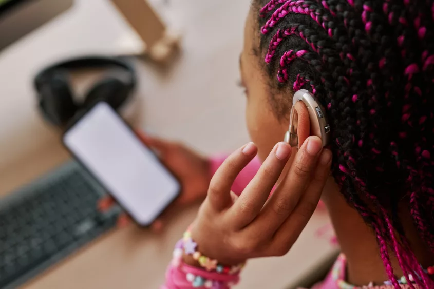 close-up-black-teenage-girl-wearing-hearing-aid-on-ear