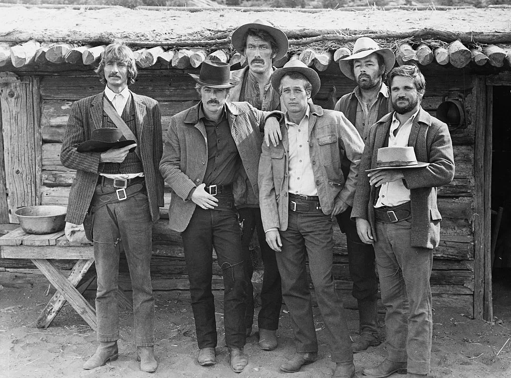 From left: Timothy Scott, US actor, Robert Redford, US actor, Ted Cassidy (1932-1979), US actor, Paul Newman (1925-2008), US actor, Dave Dunlap and Charles Dierkop, US actor, pose for a group portrait issued as publicity for the film, 'Butch Cassidy and the Sundance Kid', 1969. The western, directed by George Roy Hill (1921-2002), starred Scott as 'News Carver', Redford as the 'Sundance Kid', Cassidy as 'Harvey Logan', Newman as 'Butch Cassidy', and Dierkop as 'Flat Nose Curry'. (Photo by Silver Screen Collection/Getty Images)