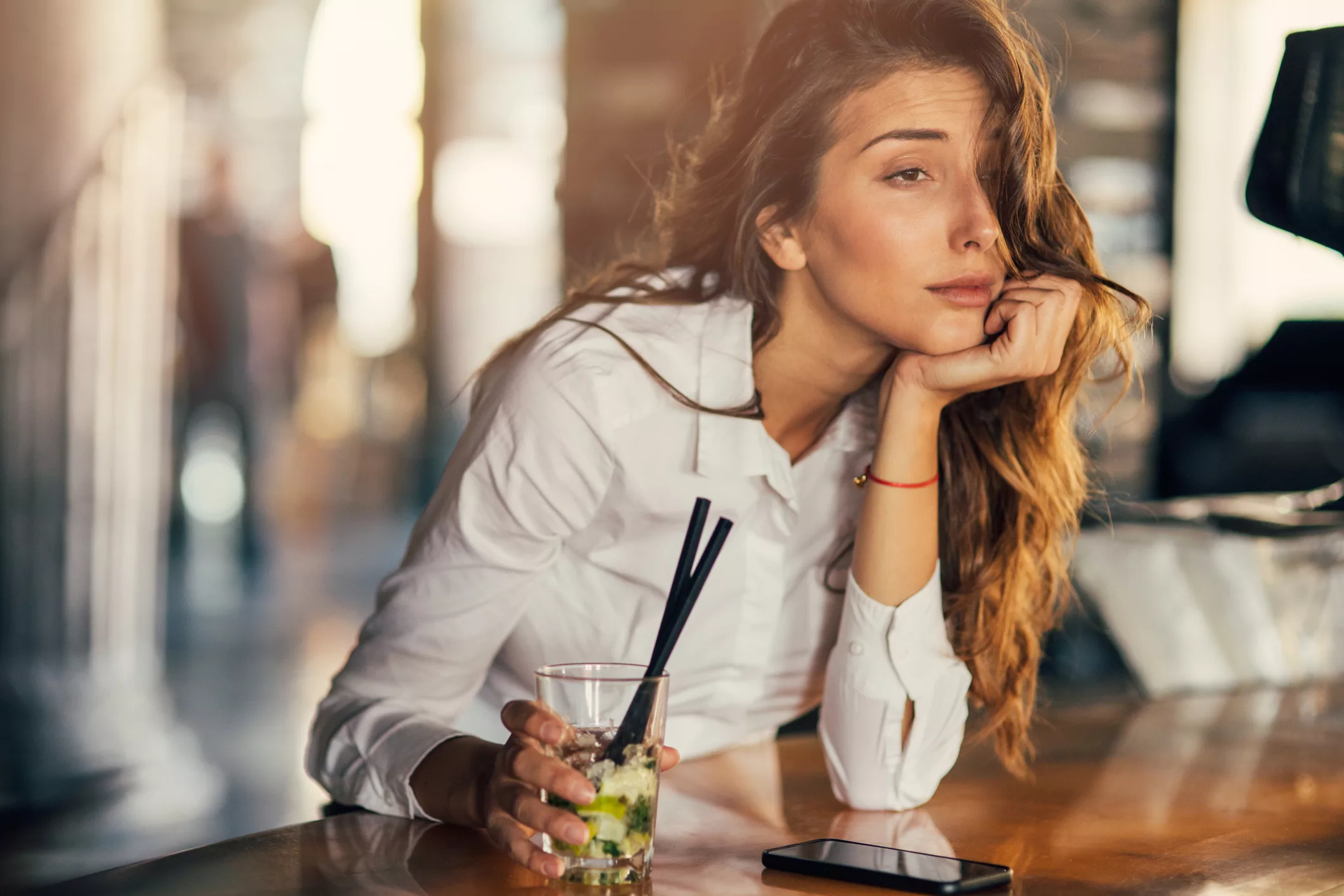 woman-drinking-cocktail-in-a-bar