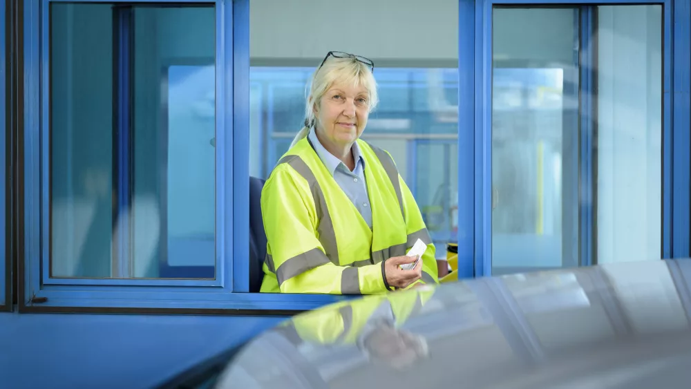 portrait-of-female-toll-collector-at-toll-booth-on-bridge