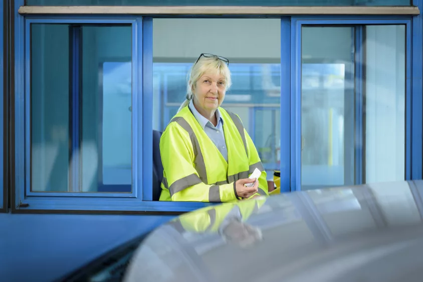 portrait-of-female-toll-collector-at-toll-booth-on-bridge