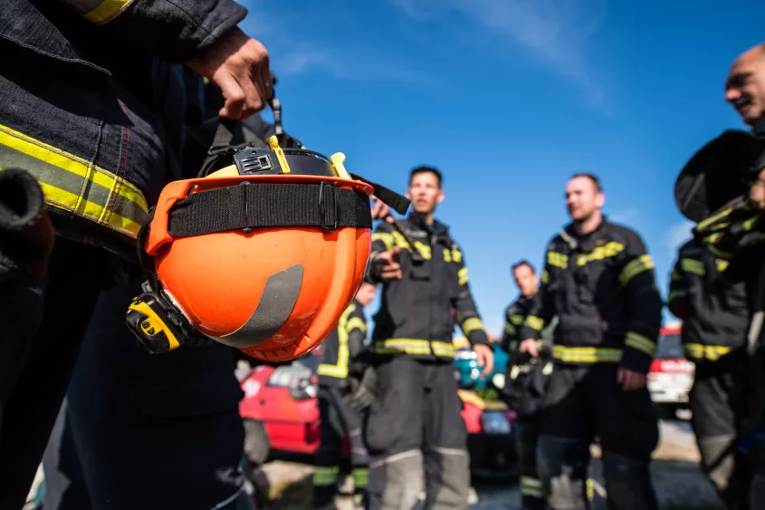 firefighter-team-discussing-outdoors-helmet-close-up