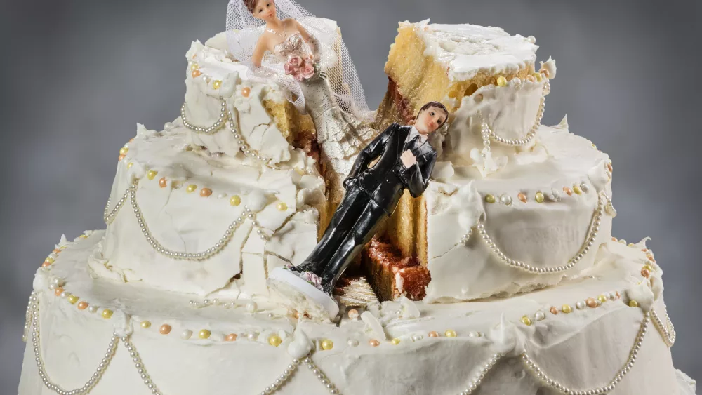 bride-and-groom-figurines-collapsed-at-ruined-wedding-cake