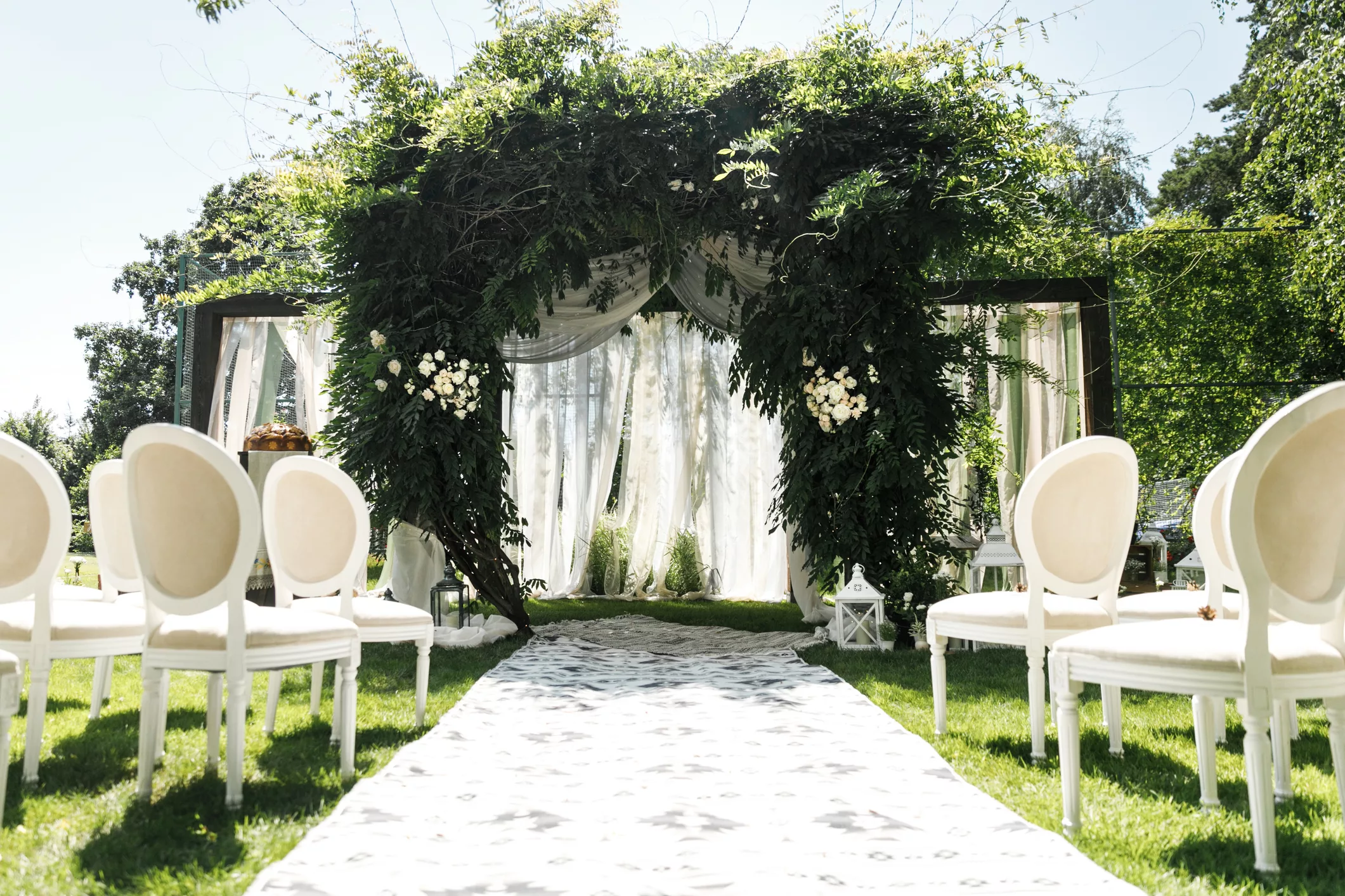 wedding-arch-decorated-with-greenery-outdoors-stock-photo