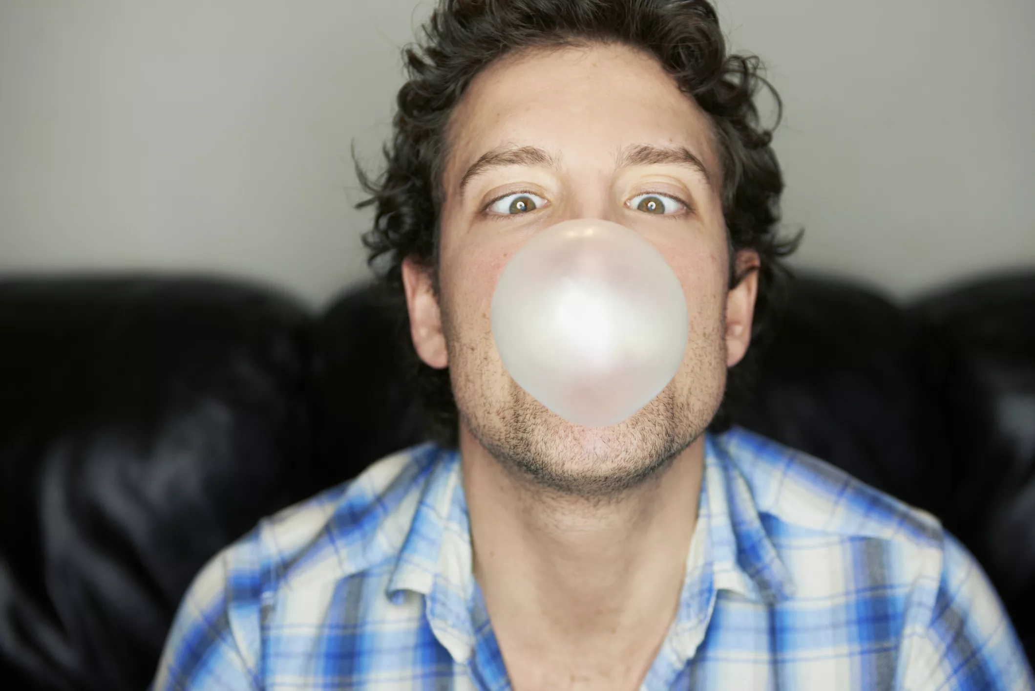 man-going-cross-eyed-blowing-chewing-gum-bubble