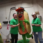 dsc02831: Justin Schlegel, Amelia Ryerse and the Orioles' Relish Condiment Mascot pose ahead of the June 28 98 Rock Night Hot Dog Race. (Photo Credit: Katarina Hein - Hearst)