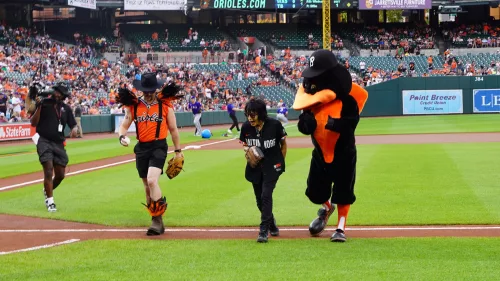 Joan Jett, American rock singer, guitarist, and songwriter walks away with Justin Masterson aka Wesley Wild and the Oriole Bird after throwing the ceremonial pitch on July 28 at 98 Rock Night 2024. (Photo Credit: Katarina Hein - Hearst)