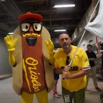 dsc02834: Scott Reardon, and the Orioles' Mustard Condiment Mascot pose ahead of the June 28 98 Rock Night Hot Dog Race. (Photo Credit: Katarina Hein - Hearst)