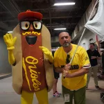 dsc02835: Scott Reardon, and the Orioles' Mustard Condiment Mascot pose ahead of the June 28 98 Rock Night Hot Dog Race. (Photo Credit: Katarina Hein - Hearst)