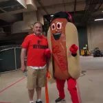 dsc02836: Josh Spiegel and the Orioles' Ketchup Condiment Mascot pose ahead of the June 28 98 Rock Night Hot Dog Race. (Photo Credit: Katarina Hein - Hearst)