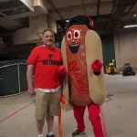 dsc02837: Josh Spiegel and the Orioles' Ketchup Condiment Mascot pose ahead of the June 28 98 Rock Night Hot Dog Race. (Photo Credit: Katarina Hein - Hearst)