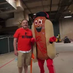 dsc02839: Josh Spiegel and the Orioles' Ketchup Condiment Mascot pose ahead of the June 28 98 Rock Night Hot Dog Race. (Photo Credit: Katarina Hein - Hearst)