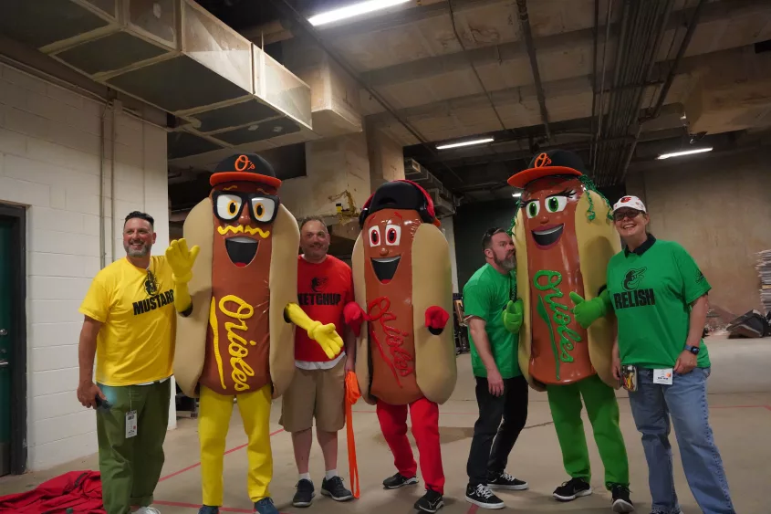 Justin Schlegel, Josh Spiegel, Scott Reardon, Amelia Ryerse and the Orioles' Condiment Mascots pose ahead of the June 28 98 Rock Night Hot Dog Race. (Photo Credit: Katarina Hein - Hearst)