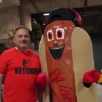 ketchup1: Josh Spiegel and the Orioles' Ketchup Condiment Mascot pose ahead of the June 28 98 Rock Night Hot Dog Race. (Photo Credit: Katarina Hein - Hearst)