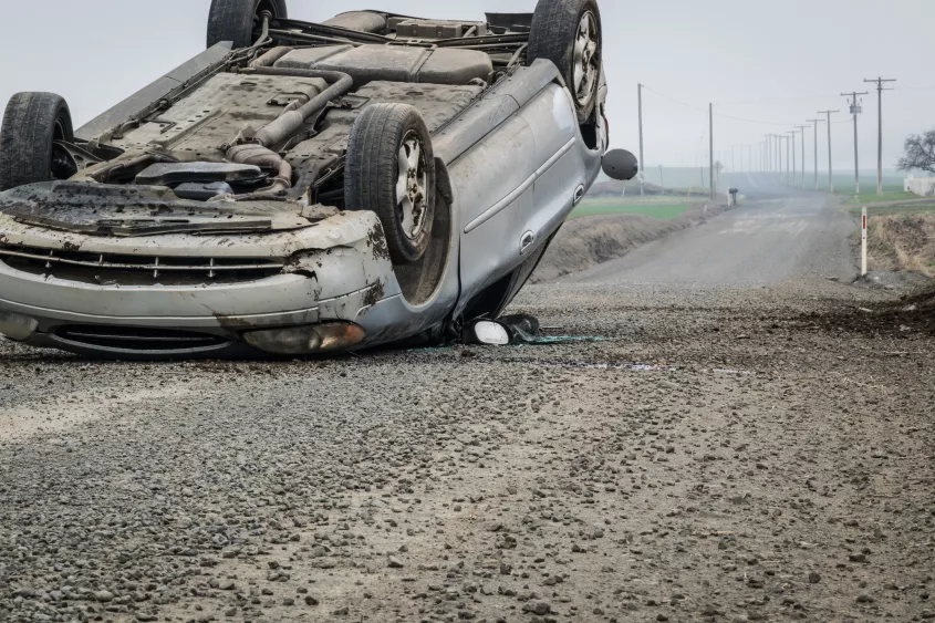 an-overturned-car-on-a-rural-road