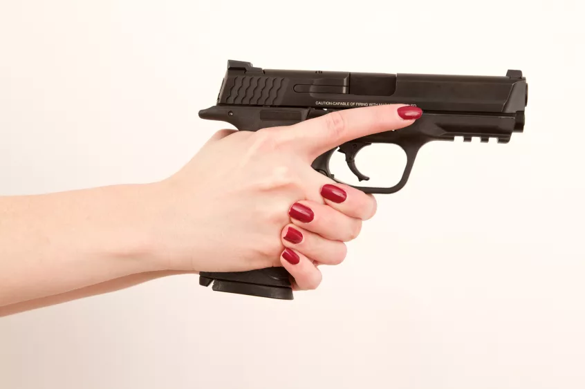 woman-holding-pistol-finger-off-trigger