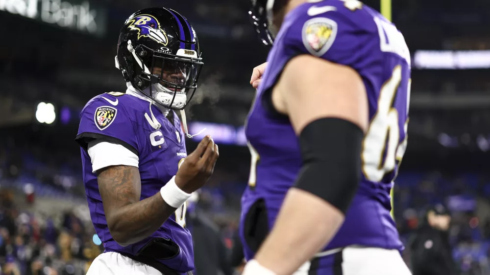 BALTIMORE, MARYLAND - JANUARY 11: Lamar Jackson #8 of the Baltimore Ravens warms up with Tyler Linderbaum #64 prior to an NFL football wild card playoff game against the Pittsburgh Steelers at M&T Bank Stadium on January 11, 2025 in Baltimore, Maryland. (Photo by Kevin Sabitus/Getty Images)