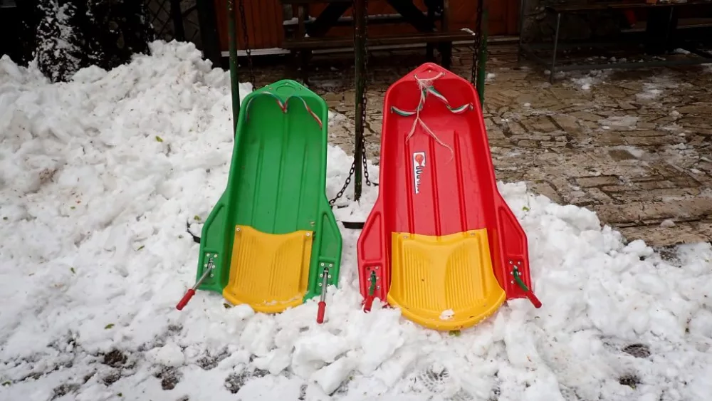 two-sleds-on-snow-on-april-21st-heavy-snowfall-covered