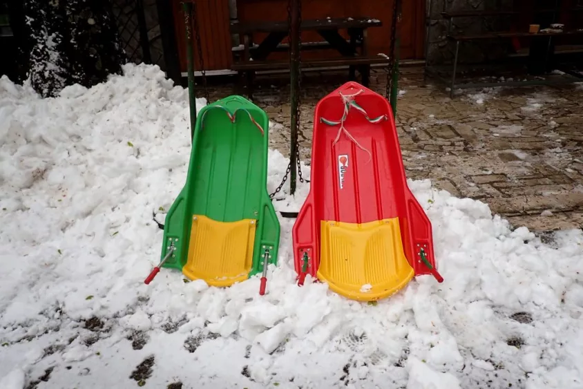 two-sleds-on-snow-on-april-21st-heavy-snowfall-covered