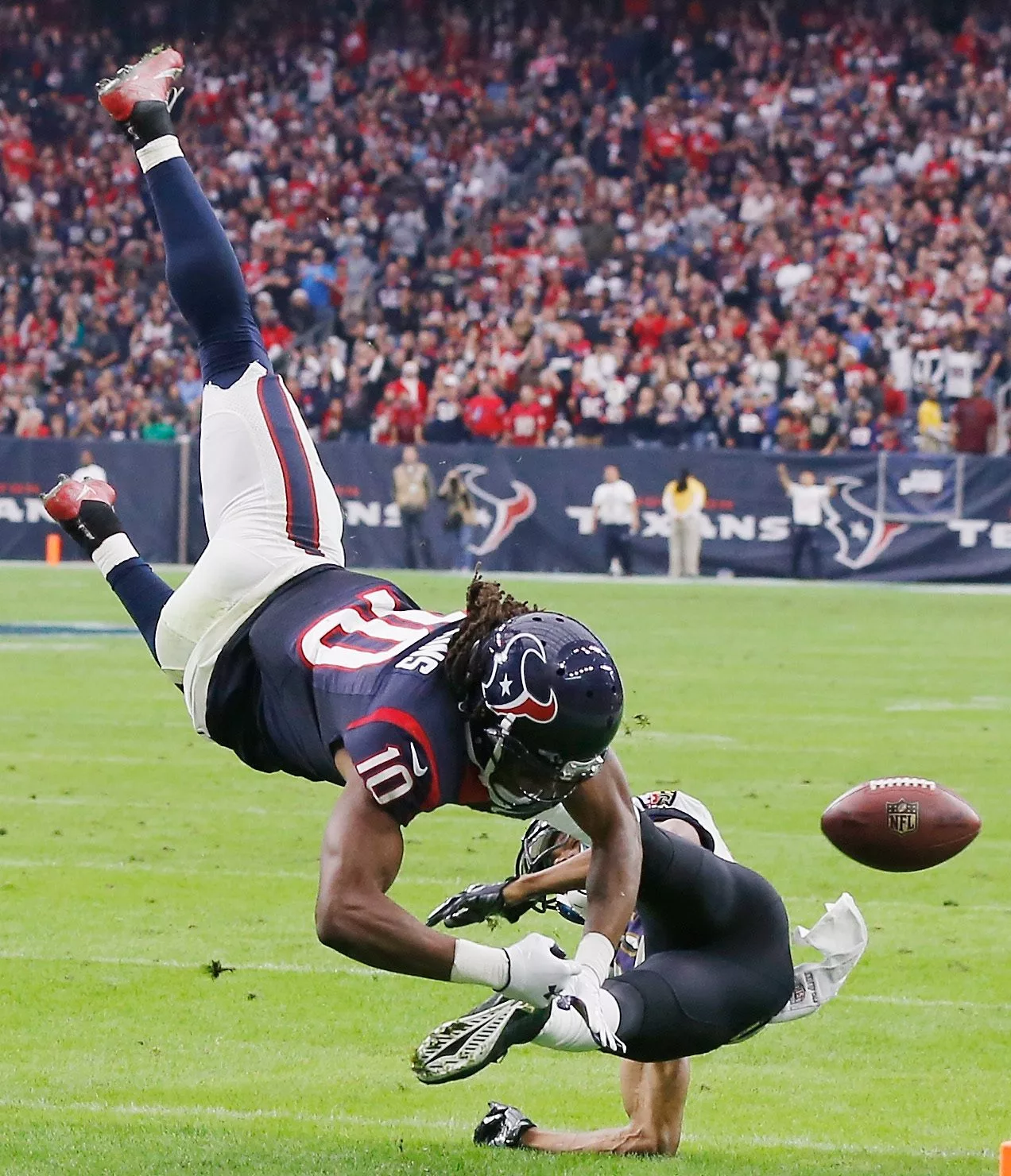 HOUSTON, TX - DECEMBER 21: DeAndre Hopkins #10 of the Houston Texans is tackled by Rashaan Melvin #38 of the Baltimore Ravens during the game at NRG Stadium on December 21, 2014 in Houston, Texas. (Photo by Scott Halleran/Getty Images)