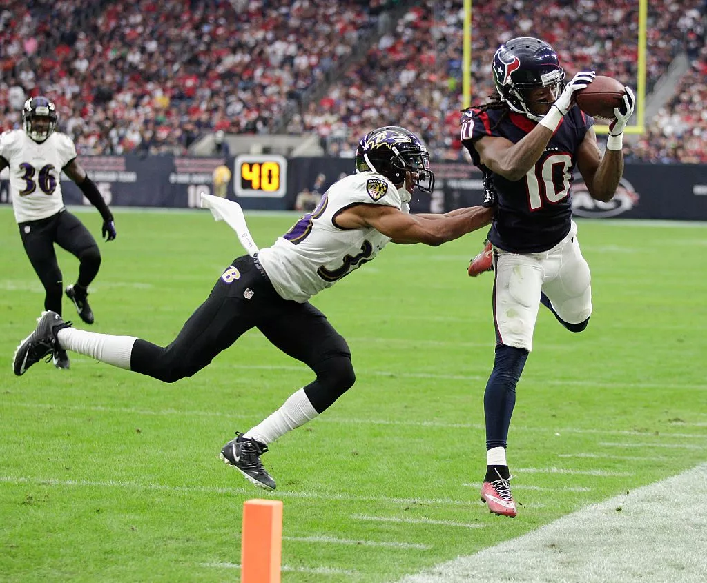 HOUSTON, TX - DECEMBER 21: DeAndre Hopkins #10 of the Houston Texans is pushed out of bounds by Rashaan Melvin #38 of the Baltimore Ravens at NRG Stadium on December 21, 2014 in Houston, Texas. (Photo by Bob Levey/Getty Images)