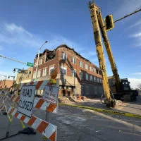 Demolition work continues Wednesday on a fire-damage building at 149-151 E. Main St.