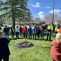 A small group of family^ friends and co-workers gathered in Standish Park on blustery Friday^ April 12^ 2024^ for a tree-planting ceremony in honor of former Galesburg city arborist Gary "Pee Wee" Johnson.