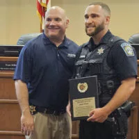 Galesburg Police Department Officer Jake Taylor^ right^ receives the 2023 Galesburg Area Crime Stoppers Officer of the Year award from GPD Chief Russ Idle.