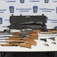 Galesburg Police display the guns they claim were taken from the home of Leslie Mixon^ 60^ during an investigation August 16. (Galesburg Police Photo)