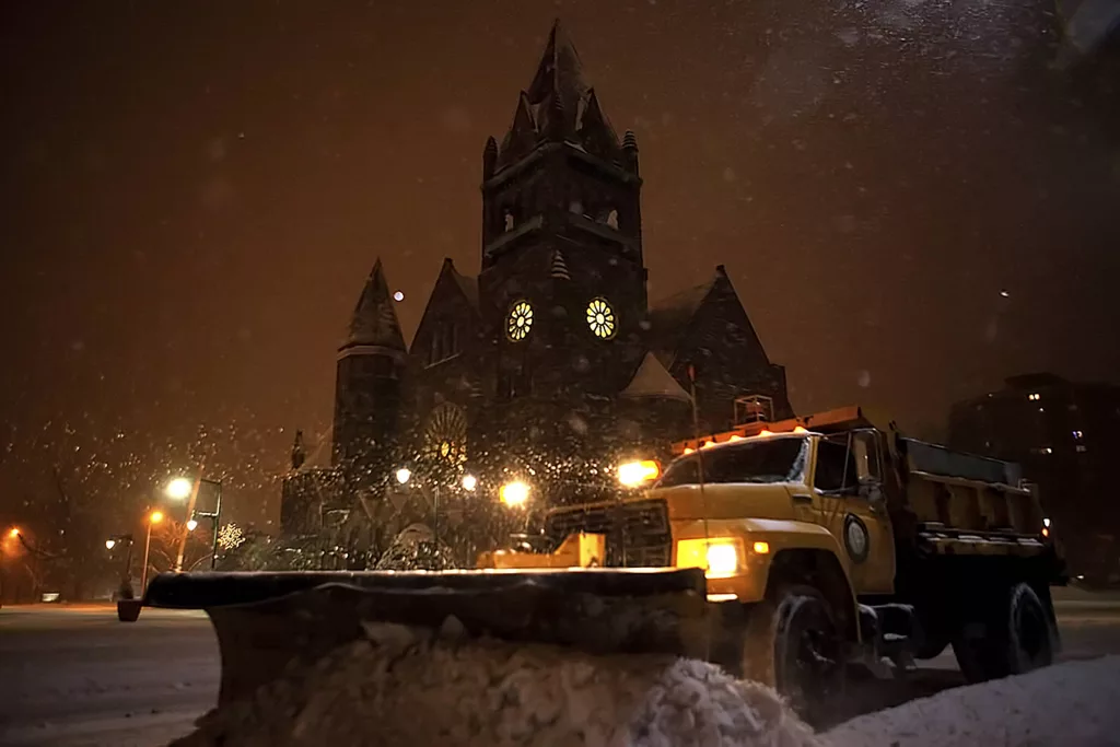 A City of Galesburg plow truck passes Central Congregational Church as it pushes snow off the Public Square during a winter storm on Jan. 5^ 2015. (STEVE DAVIS/Seedcophoto.com)