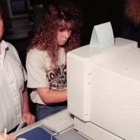 Former Carl Sandburg College math and computer science teacher Larry Schroder works with a student in the 1990s.