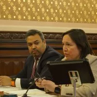 Sen. Christina Castro^ right^ and Samir Tanna^ deputy legislative director for Gov. JB Pritzker^ testify before a Senate committee Tuesday on a bill that would require all school districts in Illinois to adopt policies restricting cell phone use in classrooms. (Capitol News Illinois photo by Peter Hancock)