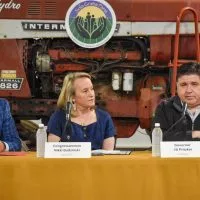 Illinois Gov. JB Pritzker^ Congresswoman Nikki Budzinski^ and Illinois Department of Agriculture Director Jerry Costello II speak at Sola Gratia Farm in Urbana^ Illinois on March 19^ 2025. Farmers and environmental leaders were also in attendance to discuss agriculture funding cuts. photo by Jennifer Bamberg^ Investigate Midwest