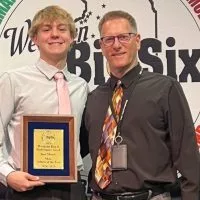 Galesburg High School senior Carson Olson and Streaks swimming coach Ray Van Hootegem.