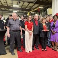 Ruth Whitehead (center)^ CEO of Pegasus Manufacturing^ Inc.^ holds her award for the 2025 SBA Illinois Manufacturer of the Year with employees during an awards ceremony at Pegasus on June 5^2025. Her husband and co-owner Ray Whitehead (left of Ruth) and SBA Illinois District Director Willette LeGrant (right of Ruth). (JAY REDFERN/WGIL)