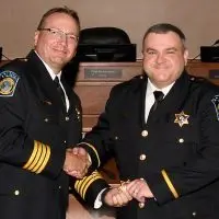 Ryne Sage^ right^ a 17-year veteran of the Galesburg Police Department^ will serve as its deputy chief. He was joined at the ceremony by Chief Kevin Legate.