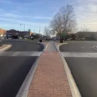 The newly narrowed traffic circle and brick-paved median slow vehicles and welcome pedestrians in Monmouth’s revamped downtown^ completed Oct. 27.