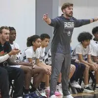 Jordan Ball coaches the Galesburg seventh-grade boys basketball team during a game.