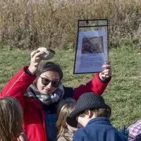 Teacher Natalie Brown with students at Bluestem Hall Nature School in Urbana during an outdoor class on October 30^ 2025. (Photo: Darrell Hoemann / Investigate Midwest)