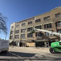 tto Baum Company restoration equipment and workers repairing the Weinberg Arcade building in downtown Galesburg