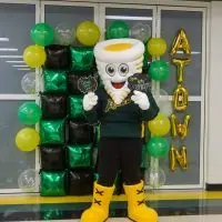Tommy Tornado mascot at Abingdon-Avon schools with spirit signs and balloons