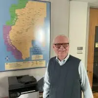 Owen Muelder standing beside the West Central Illinois Underground Railroad map at Knox College in Galesburg^ Illinois
